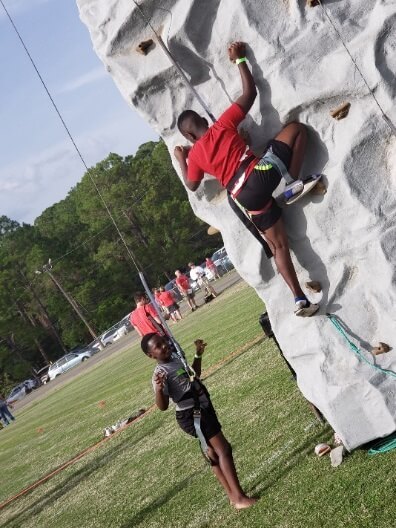 kids climbing rock wall.