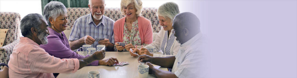 Six senior citizens playing a card game