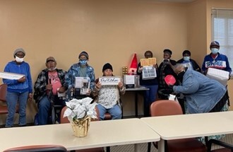 Pictured Left to Right: Elderly Village Christmas Bingo Participants 