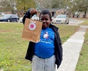 THA Resident Kayden holding holiday art kit