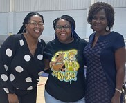 Three women smiling and posing