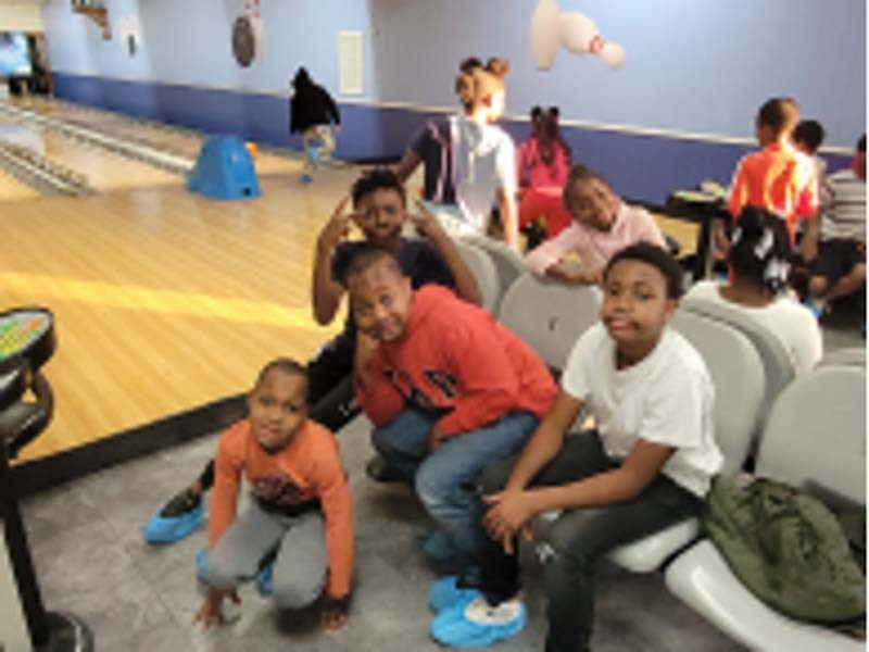 A group of kids gathers together for a photo at the Youth Bowling Event.