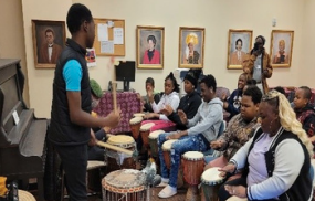 Students learning about drums from Africa.