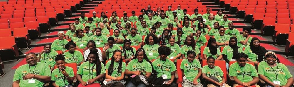 Students in stadium seating for a group photo. 