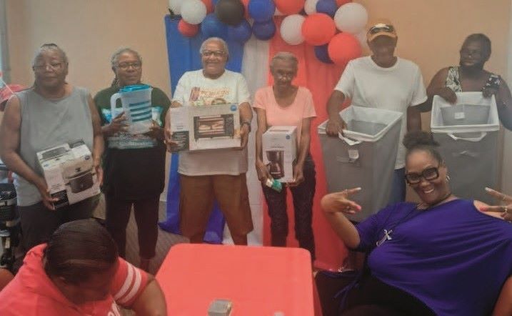 Group of seniors showing off their bingo prizes. 