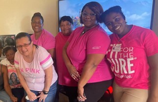 A group of ladies celebrating Breast Cancer Awareness Month.