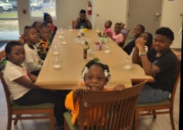 Children at a table making snow globes at the Youth Center.