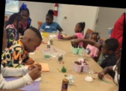 Kids at a table making snow globes at the Youth Center.