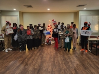 Various residents holding their Bingo Prizes.