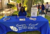 People behind a table for Georgia Legal Services program.