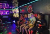 Row of kids playing video games.