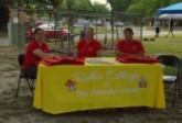 Three ladies sitting behoind a table for Ruths cottages.