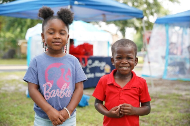A young boy and girl smile for a picture.