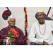 A woman holding flowers with a man sitting next to her