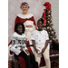 2 little girls on Santa's lap with Mrs. Claus standing behind him