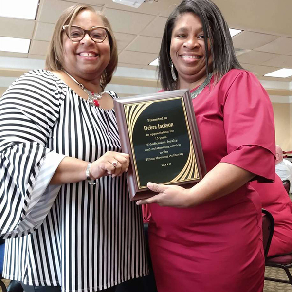 Ms. Clark presenting a 15 years service recognition plaque to Debra Jackson