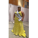 Seneca Clark stands smiling in her evening gown. A diamond studded crown sits on her head and 2 sashes are draped across her shoulders.  