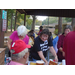 A volunteer smiles at a resident as she shows him an ice-cream carton. 