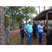 Residents are gathered together, standing and sitting, to listen to music and discussions.