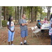 Two residents stand to the side watching the on-going discussion.