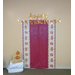 A table a fall themed table cloth is tapped to the wall with the words Happy Thanksgiving tapped above it. Some hay bales and pumpkins are stacked up to the left to create a photo backdrop area. 