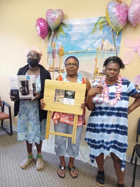 MothersDayBINGOatElderlyVillage2023Resized.jpg Three Bingo Winners pose with their prizes.