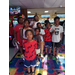 A group of kids posing in an arcade.