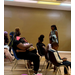  A woman speaking to a room full of people. 
