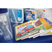  A table with books, and water bottles laid out. 