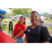  Two people sit and smile for a picture. 