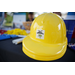  A yellow plastic hard hat that reads Play it safe around electricity! 