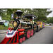  A man driving a train around for kids to ride in. 