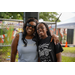  Two women hug and smile for a picture. 