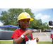  A young girl wearing a yellow hard hat. 