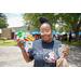  A woman smiling and holding gift cards that she won. 